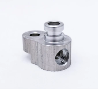Milled aluminium block with a sleeve and a cross hole